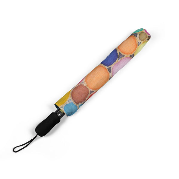Colorful umbrella cover with a pattern of round shapes on a white background