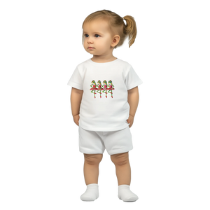 Child wearing a white t-shirt and shorts set with a colourful dancing frog princess design on a white background